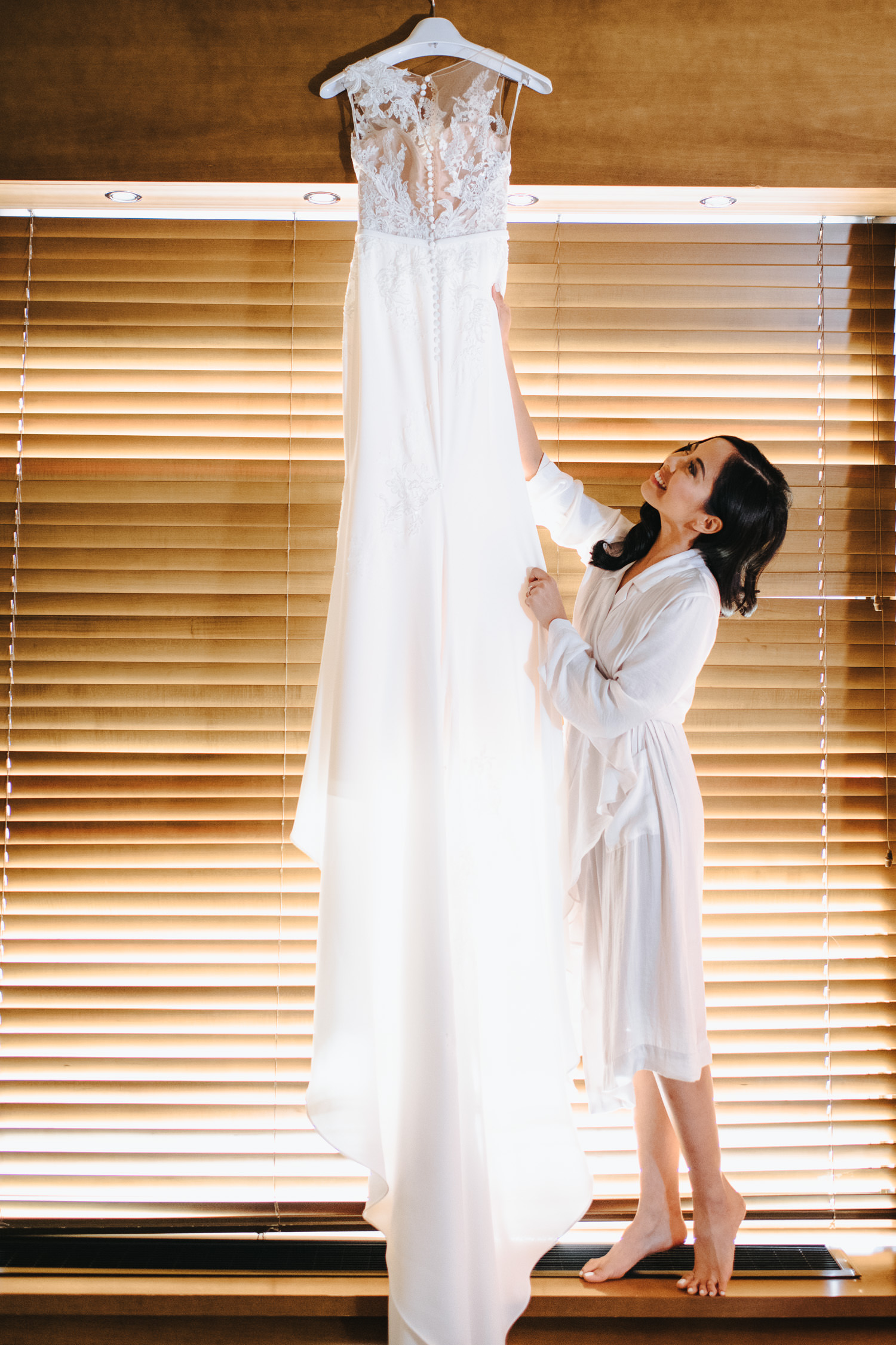 Bride putting on her wedding gown at Le Germain on Mercer
