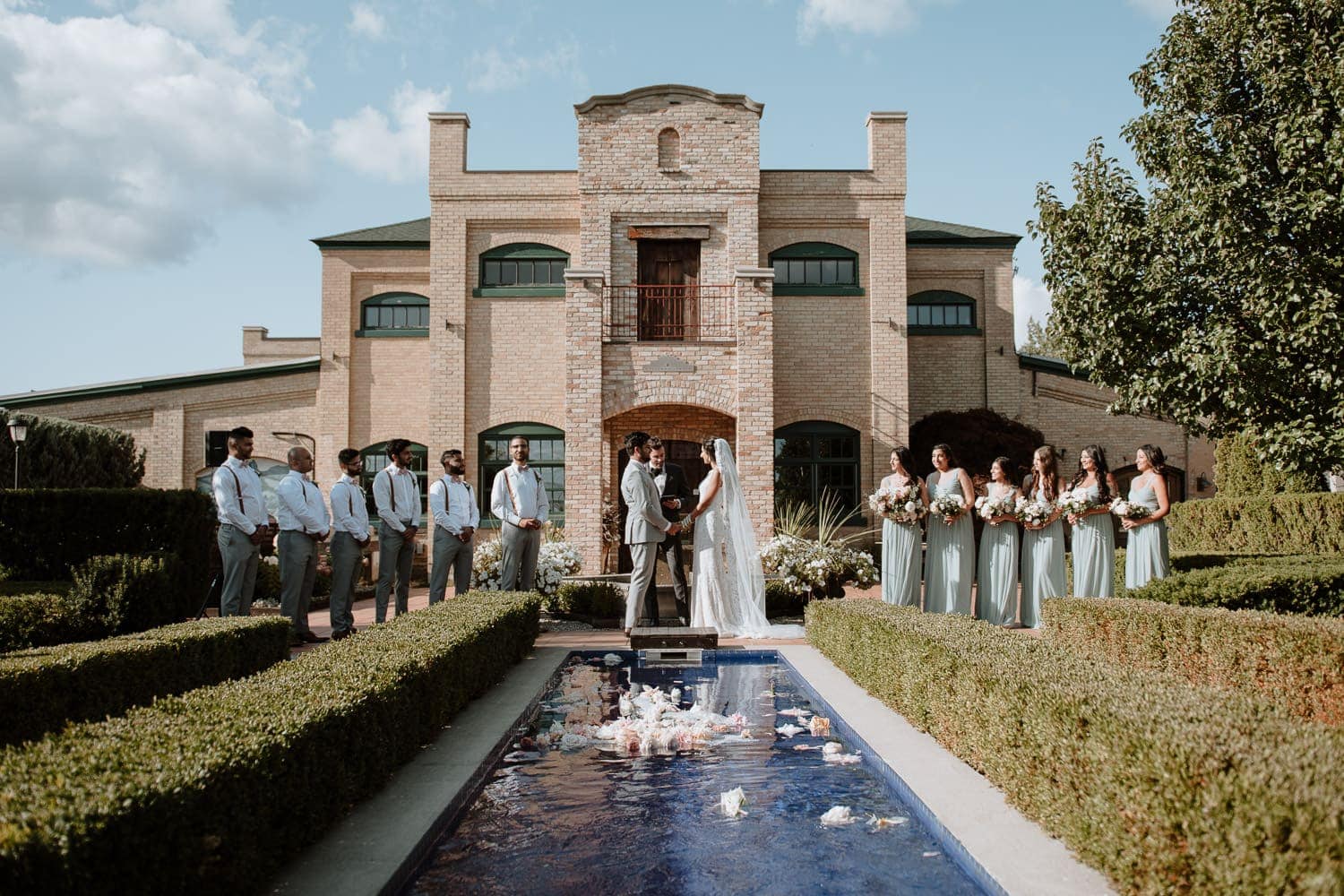 Outdoor wedding ceremony at the garden of Hacienda Sarria in Kitchener, Ontario