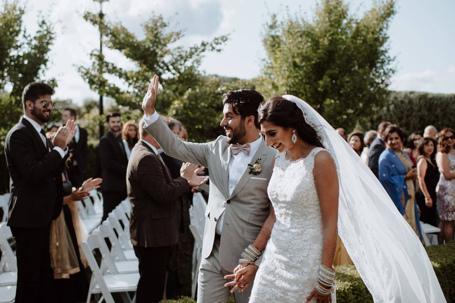 Bride and groom exit the wedding ceremony at Hacienda Sarria in Kitchener, Ontario