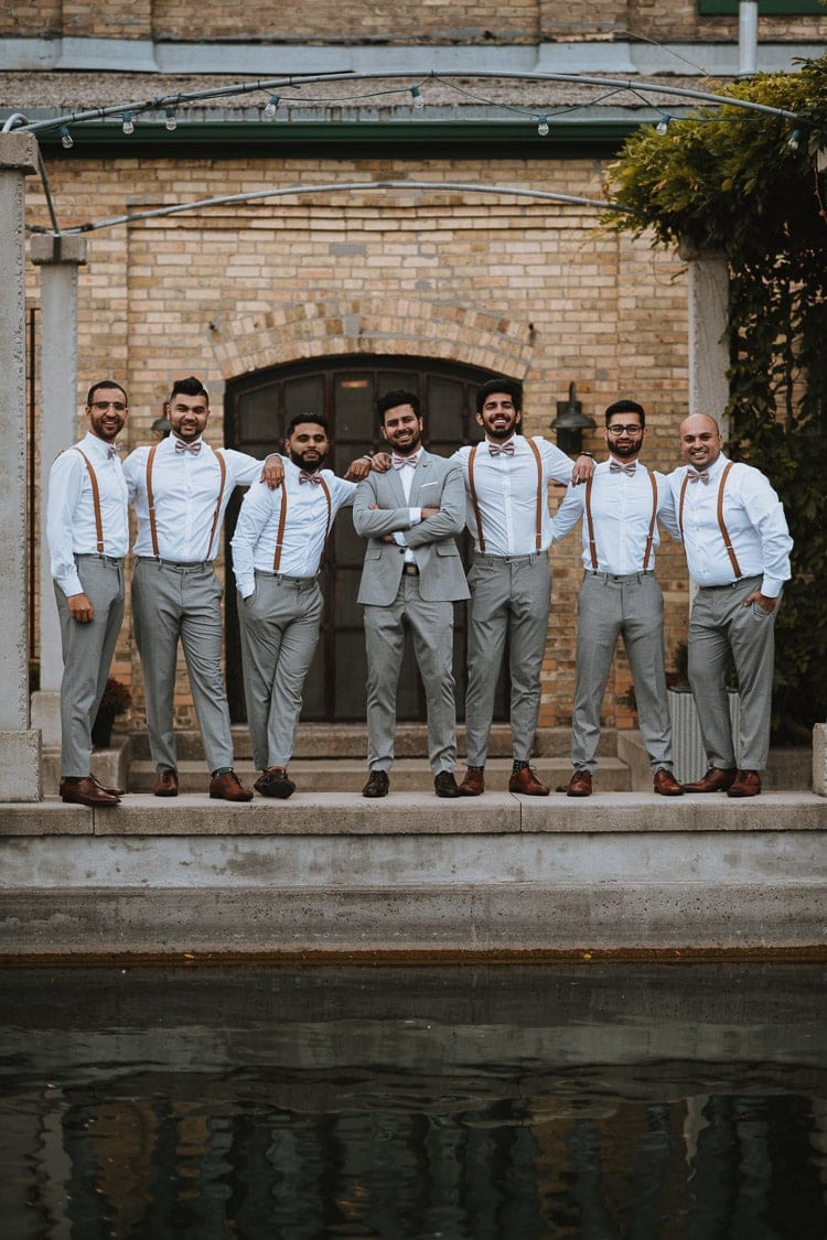 Groom and groomsmen posing at the patio of Hacienda Sarria