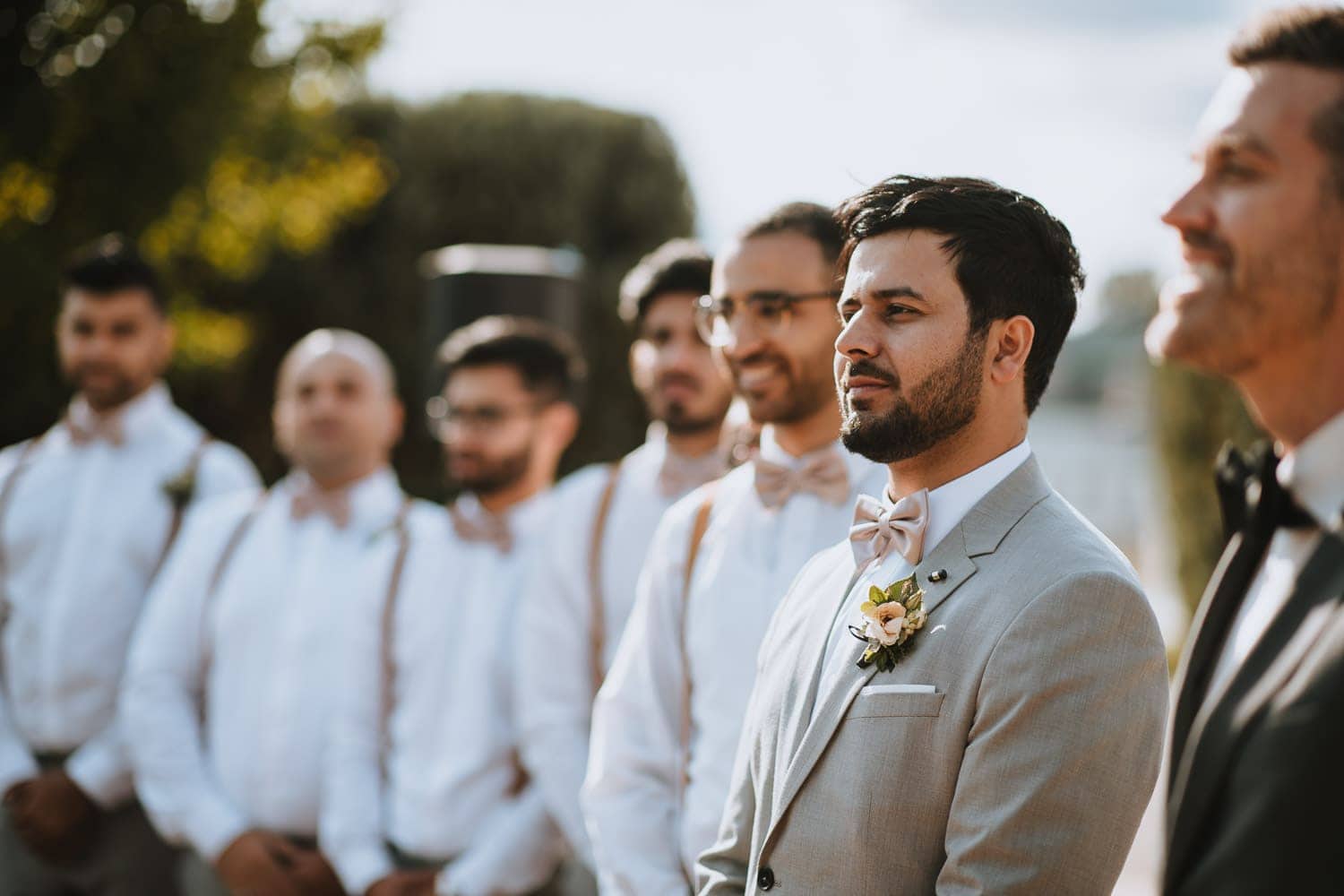 Groom anticipating bride entrance at outdoor wedding ceremony in Kitchener, Ontario