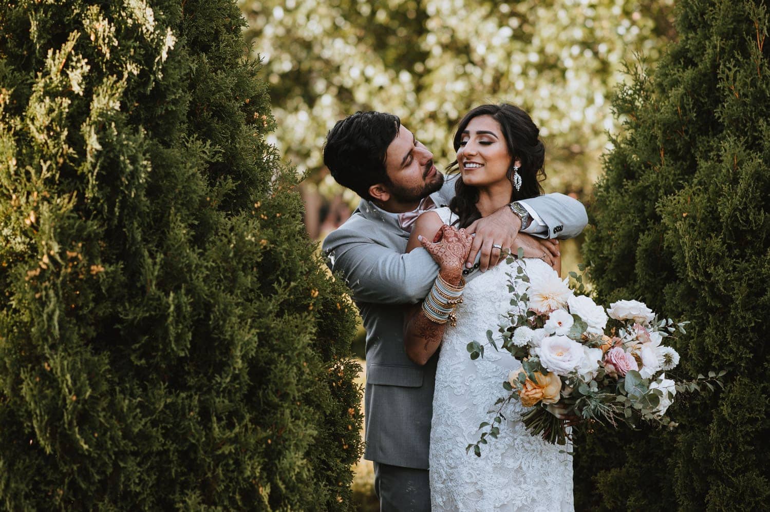 Candid portrait of bride and groom in the garden of Hacienda Sarria