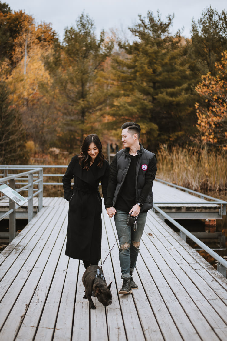 Couple's engagement session with their dog at the boardwalk of Evergreen Brickworks in Toronto
