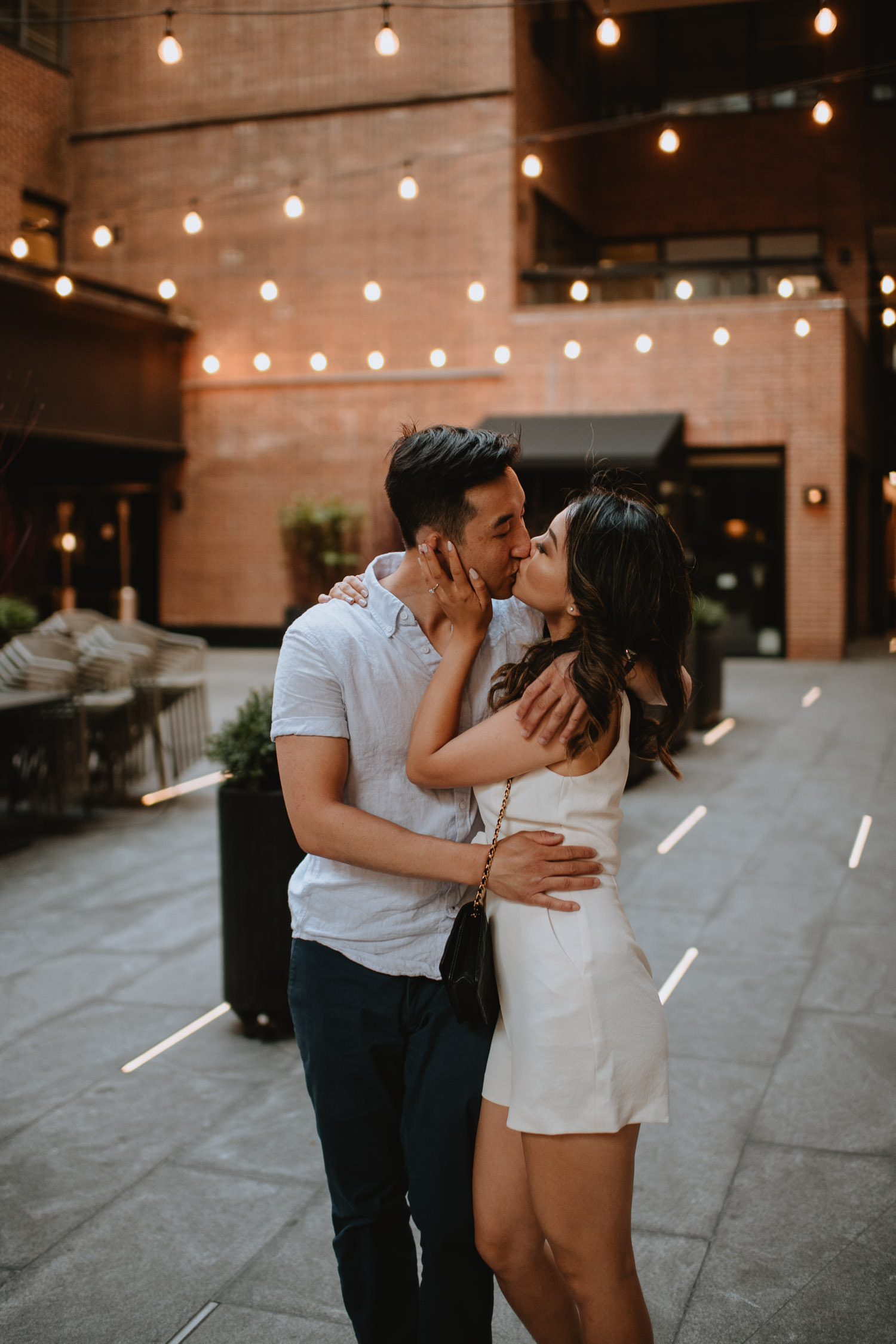 Couple's engagement session under the string lights in downtown Toronto Yorkville