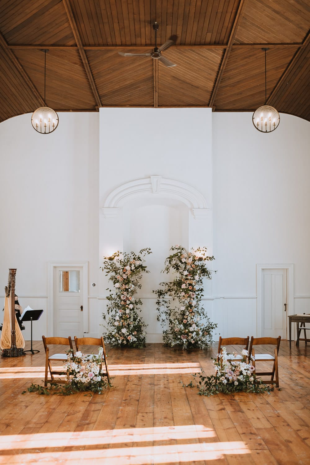Cranberry Creek Gardens intimate chapel wedding decor with open floral arches
