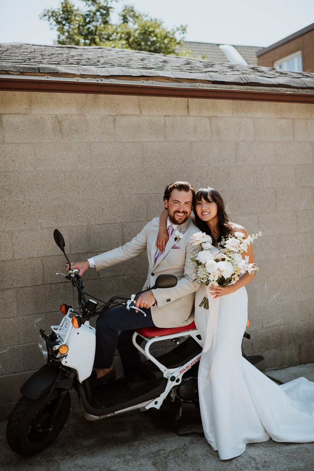 Toronto Backyard Micro Wedding Photo with bride and groom on their bike