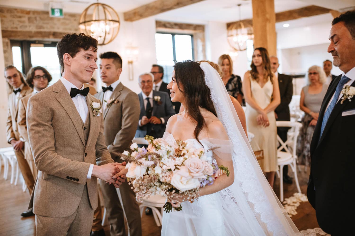 elora mill indoor chapel ceremony bride hand off