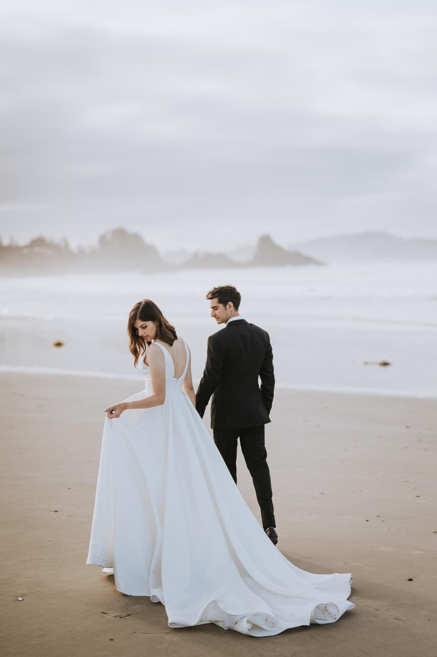 A portrait of a wedding couple at a Tofino beach at sunrise