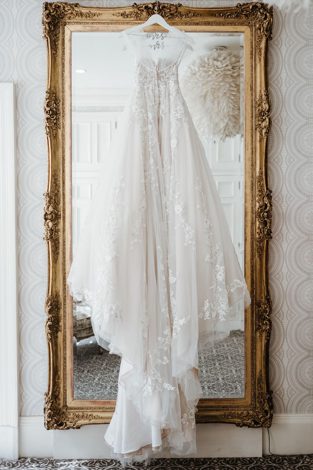 wedding dress hanging in bridal suite