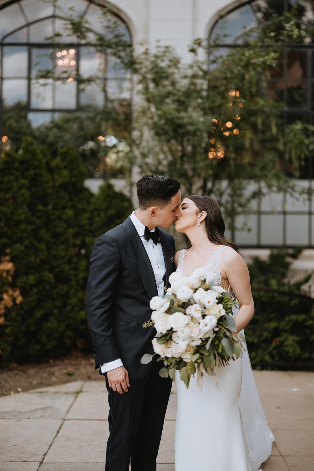 Casa Loma Wedding Portrait of bride and groom in front of the conservatory