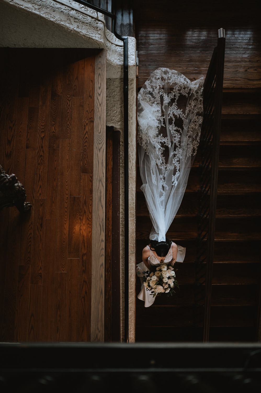 Bridal portrait with her wedding dress at the staircase of Casa Loma Toronto