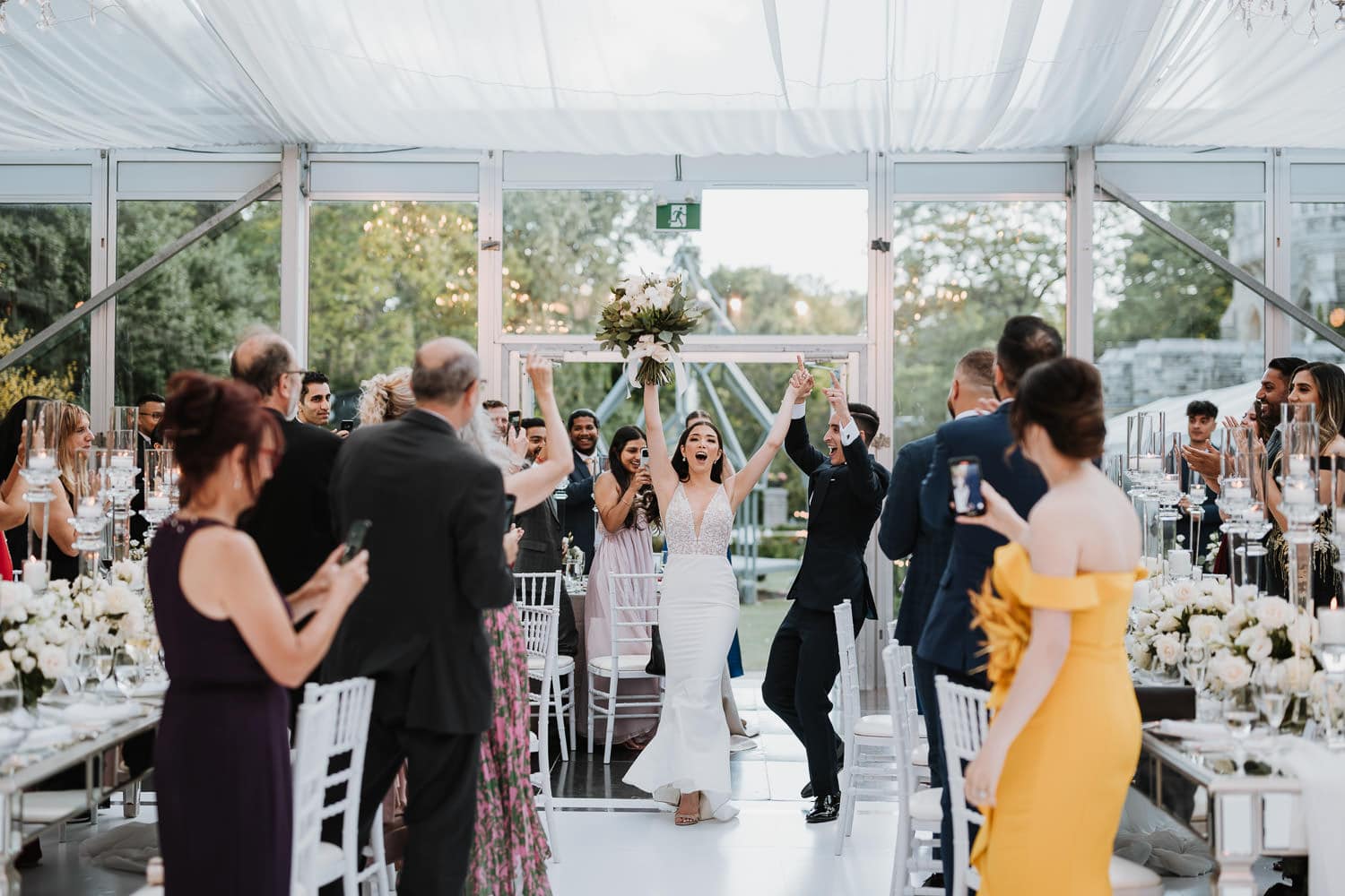 Bride and groom grand entrance at the Casa Loma glass pavilion